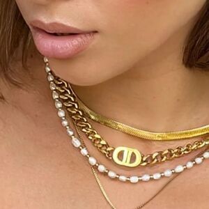 18k gold-plated chain necklace and bracelet set featuring a "DD" logo charm.